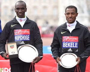 a couple of men holding silver medals