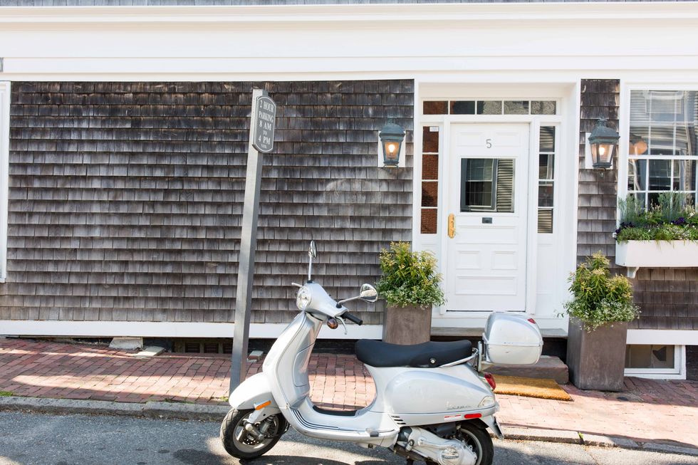 Scooter, Property, Vehicle, Wall, House, Vespa, Window, Home, Real estate, Automotive design, 