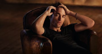 a seated individual exhibiting signs of distress or contemplation