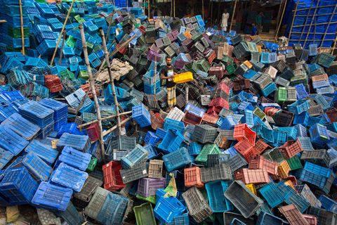 A garbage collector in Dhaka Bangladesh gathers up discarded plastic fruit boxes with plans to resell them Recently the US Air Quality Index ranked Dhaka Bangladesh as the most polluted city in the world