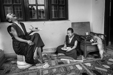 Een paar jonge boeddhistische monniken maken plezier tijdens een maaltijd in Kathmandu Nepal Kinderen zijn kinderen overal ter wereld zegt Your Shotfotograaf Jorge DelgadoUrea