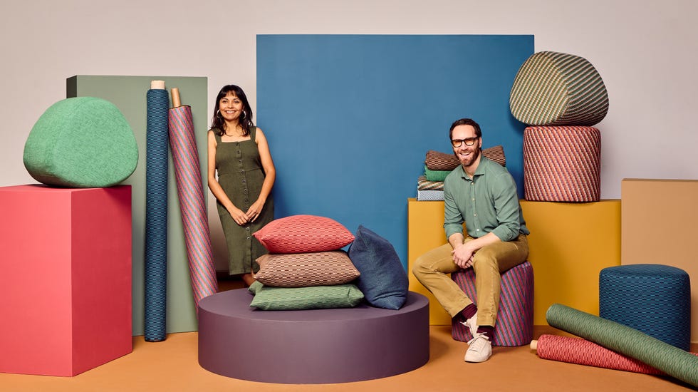 Display of colorful textiles and cushions arranged artfully.