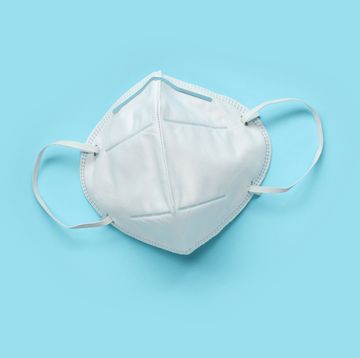kn95 face mask on blue background protection against pm 25 polution and covid 19 coronavirus healthcare and medical concept