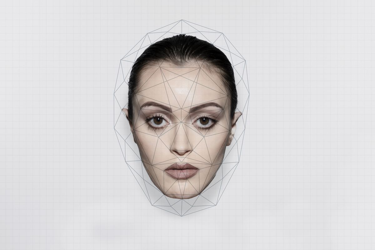 face recognition analyzing on woman's face over white background
