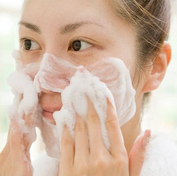 woman using face wash