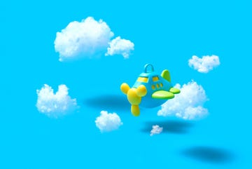 toy airplane in clouds face your fear of flying