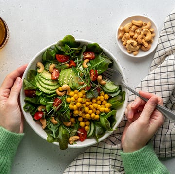 faceless female eating healthy vegan plant based salad in bowl with fatty acids and dietary fiber