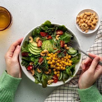 faceless female eating healthy vegan plant based salad in bowl with fatty acids and dietary fiber