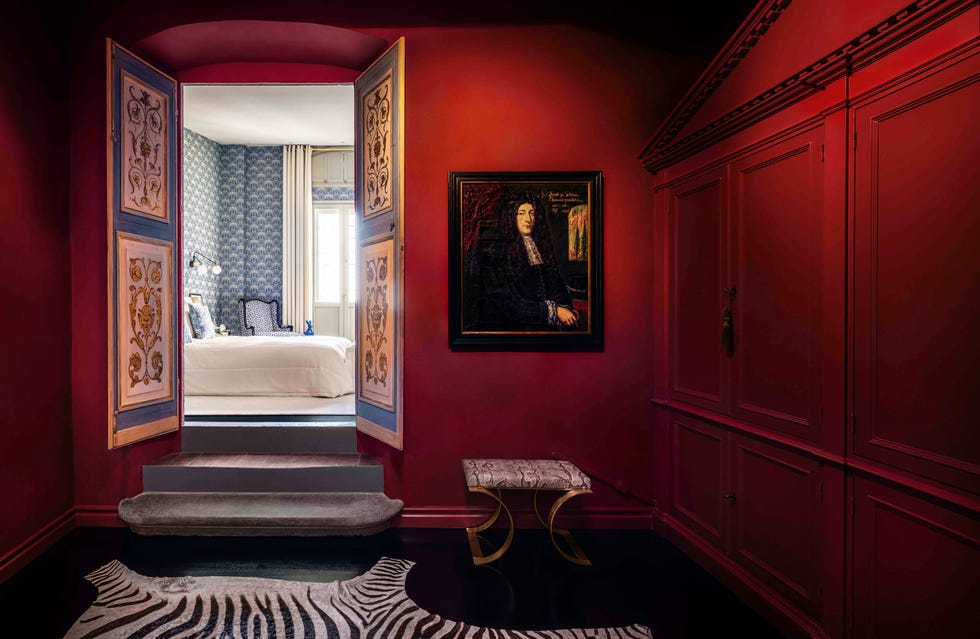 the red lacquered walls of osorio's dressing room, inspired by yves saint laurent's paris apartment