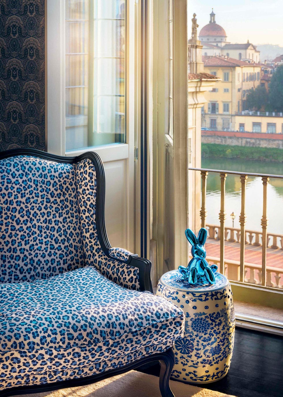 a corner of osorio's bedroom, where an artwork by jeff koons sits beside a vintage chair