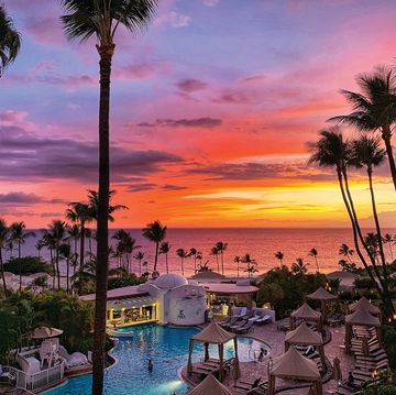 sunset looking out to ocean over upper pool at fairmont kia lani in maui