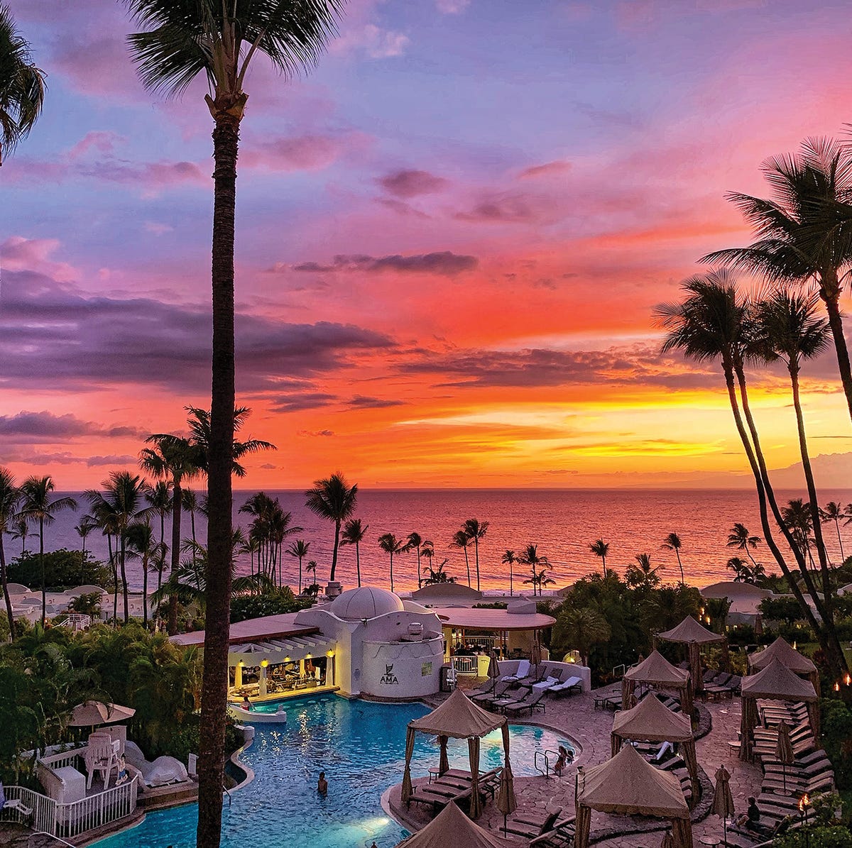 sunset looking out to ocean over upper pool at fairmont kia lani in maui