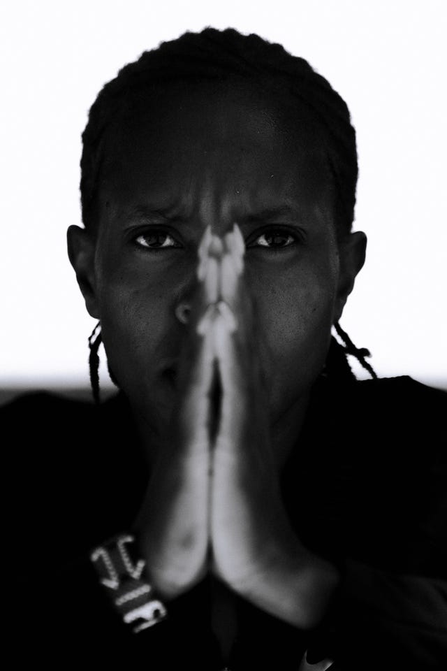 faith kipyegon with her hands together against her face