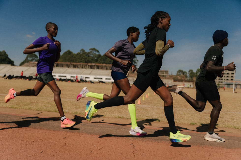 faith kipyegon running on a track alongside three other athletes