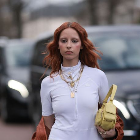paris, france march 05 marie gaguech seen wearing a white lacoste shirt, skirt, orange miu miu leather jacket, yellow miu miu handbag, golden necklace chains outside lacoste show during the womenswear fallwinter 20242025 as part of paris fashion week on march 05, 2024 in paris, france photo by jeremy moellergetty images