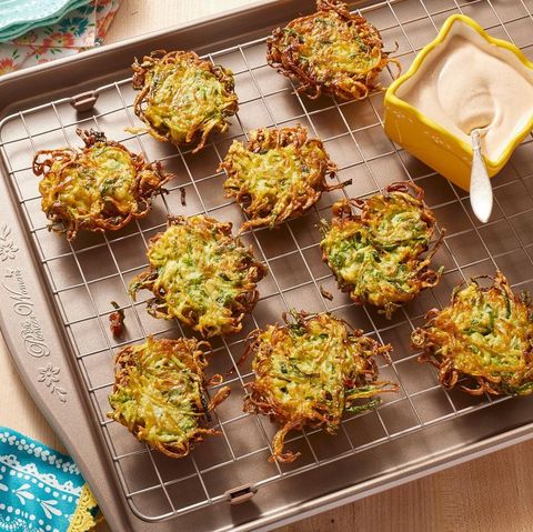 zucchini fritters on wire rack with crema