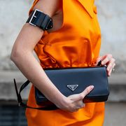 milan, italy   february 24 alexandra pereira seen wearing orange dress, belted bags around arms, bag outside prada fashion show during the milan fashion week fallwinter 20222023 on february 24, 2022 in milan, italy photo by christian vieriggetty images