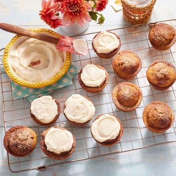 pumpkin muffins with cream cheese frosting on wire rack