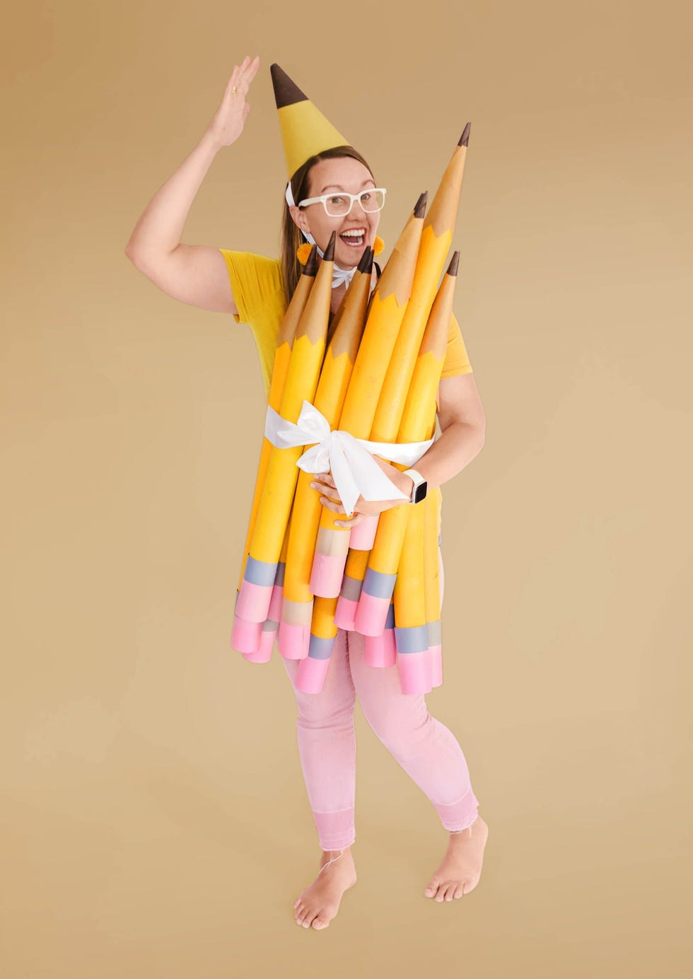 a woman dressed up like a bundle of pencils for a diy halloween costume