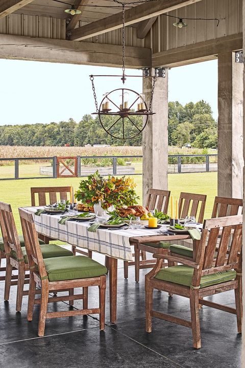 covered outdoor porch with a formal dining table set up