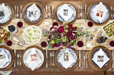 thanksgiving table set with family photo place settings and pretty flowers