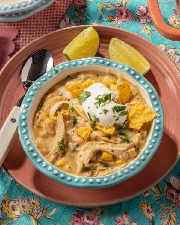 white chicken chili with lime wedges