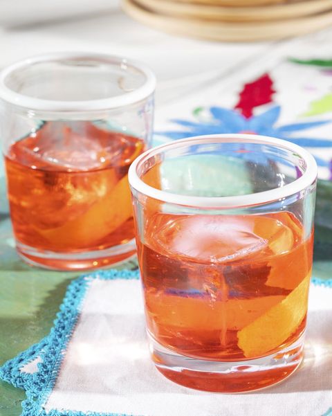 two mezcal negronis in glasses with white rims