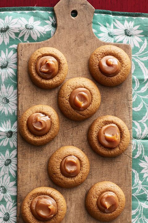 gingerbread thumbprint cookies with dulce de leche on wood board
