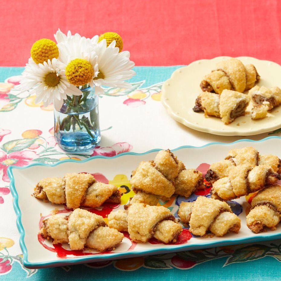 rugelach on platter with white and yellow flowers in back
