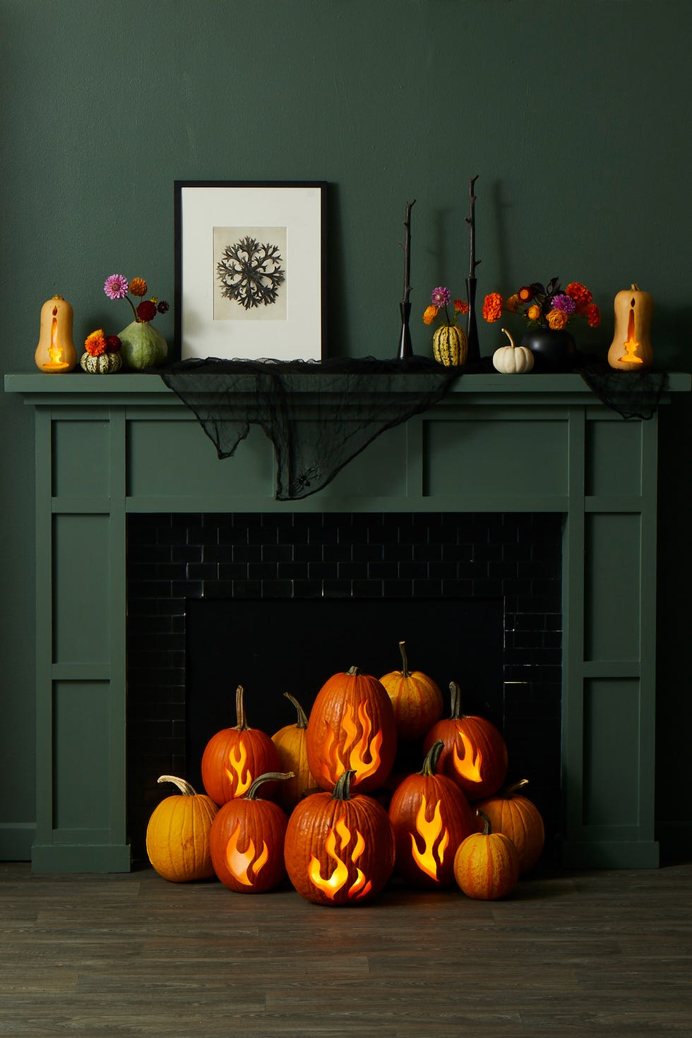 fall crafts, pumpkins in front of the fireplace with carved flame designs