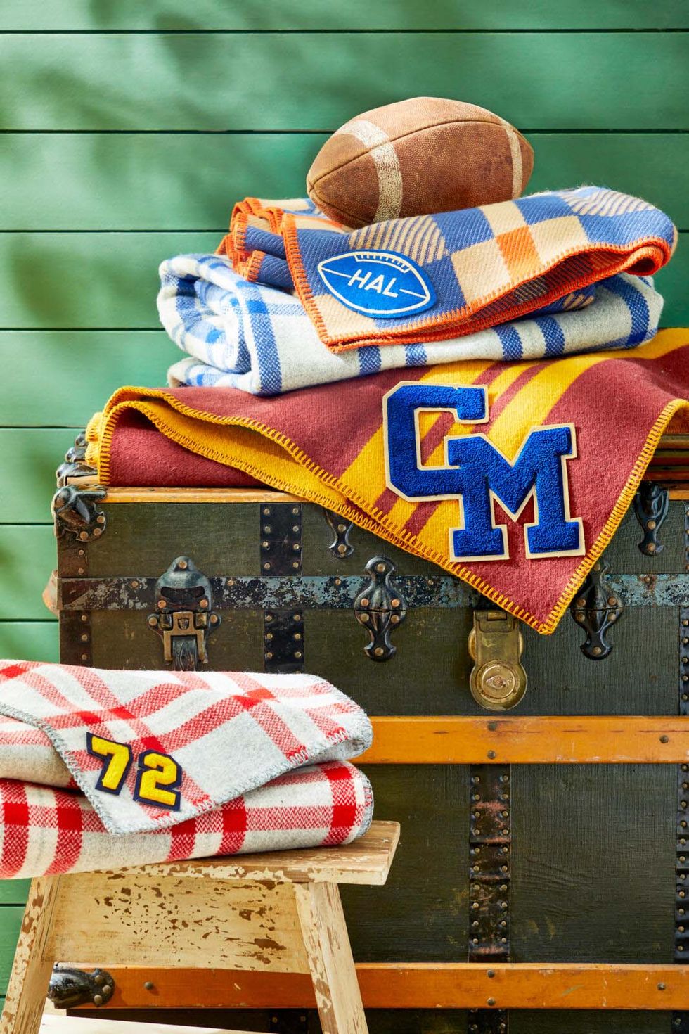 fall colored wool blankets with vintage letterman patches and numbers attached to them
