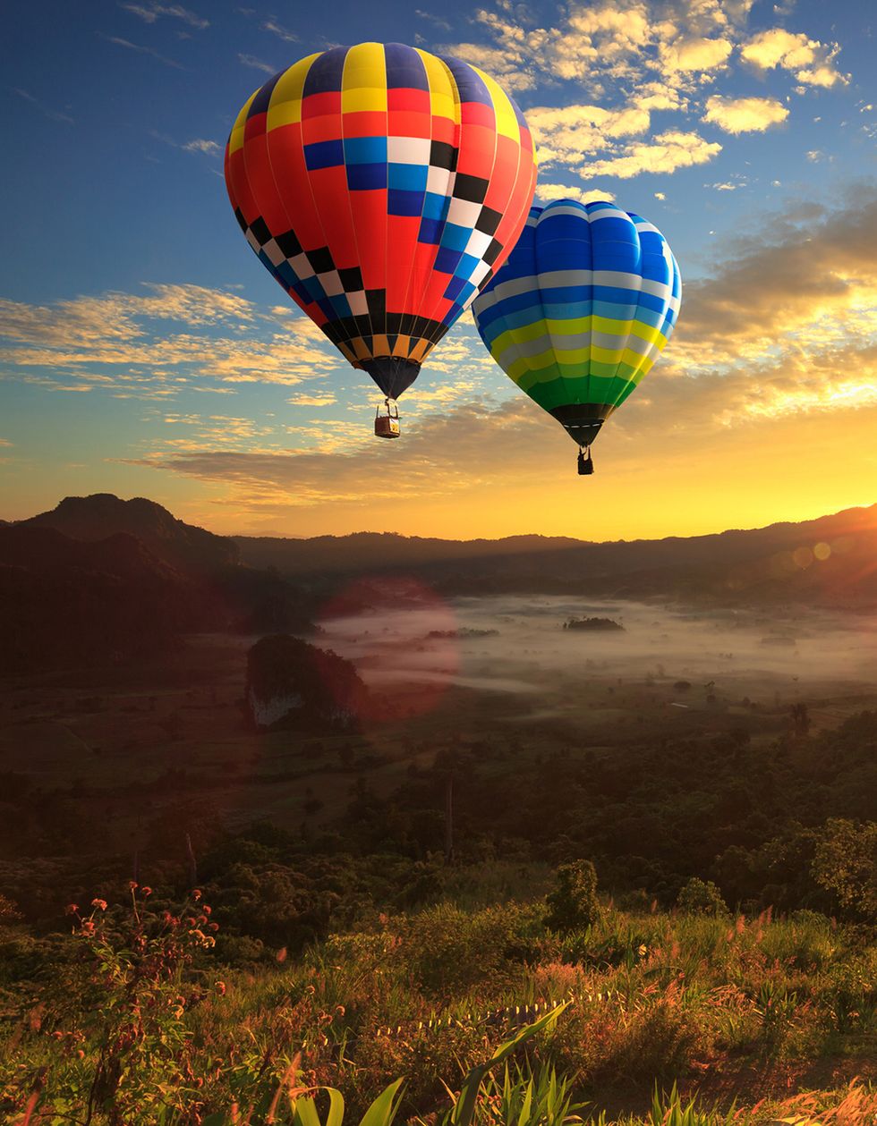 two hot air balloons rising over beautiful natural scenery fall date ideas