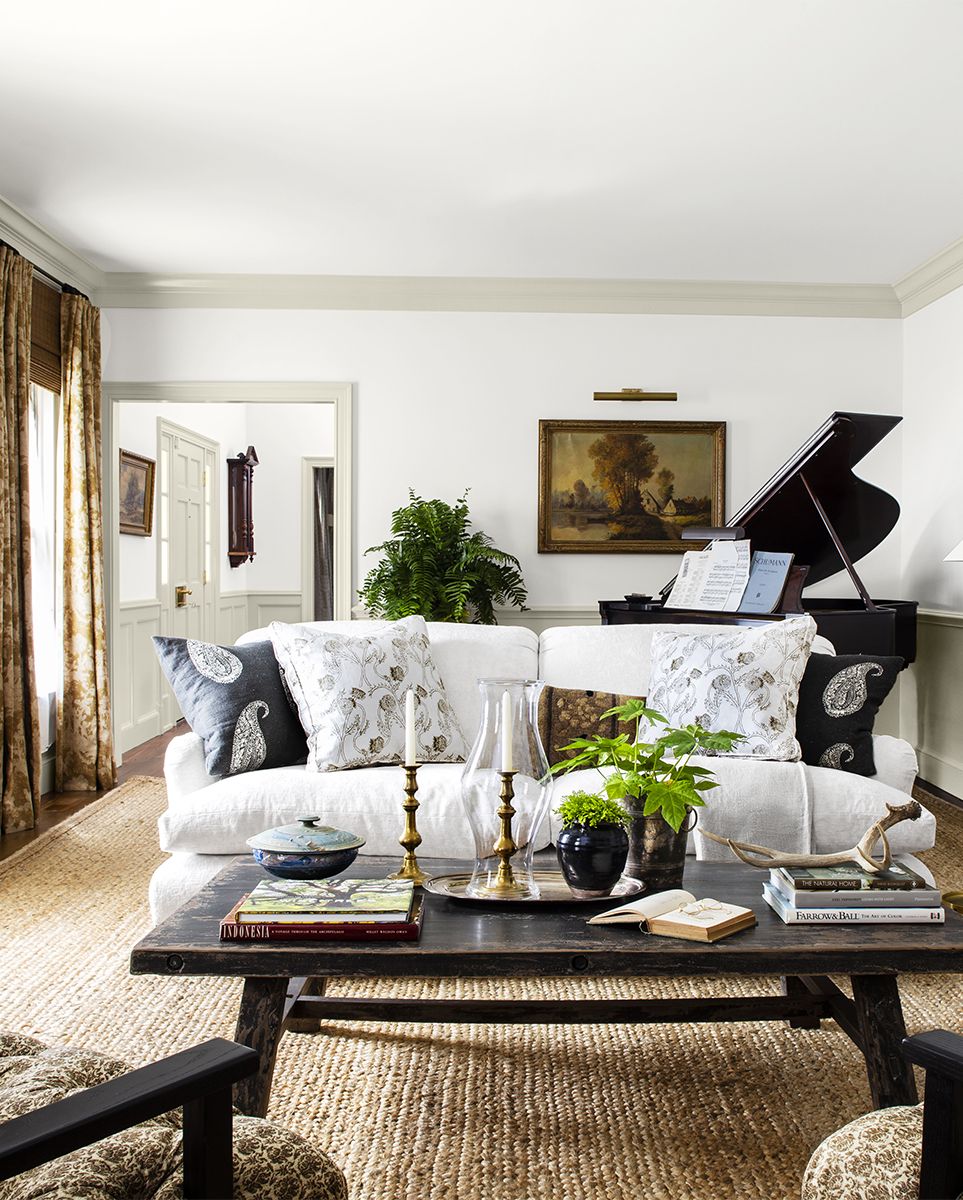 colonial revival home designed by lauren liess living room with piano, white sofa, brown furniture