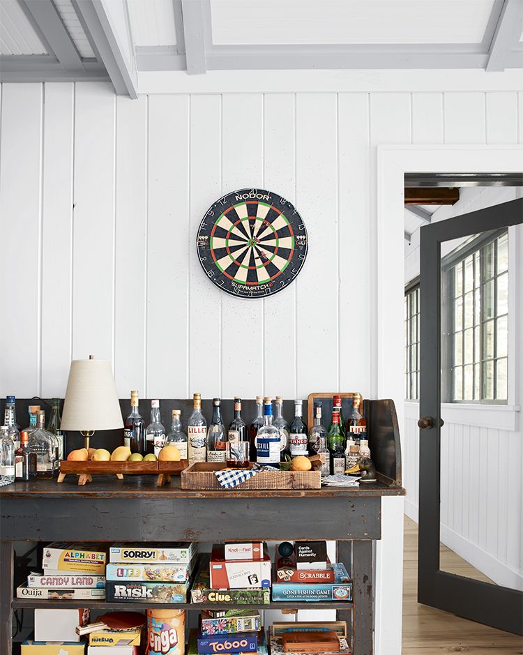 vacation home of vincent mazeau and natasha mazeau in new york’s copake lake an old post office sorting table with bar set and games