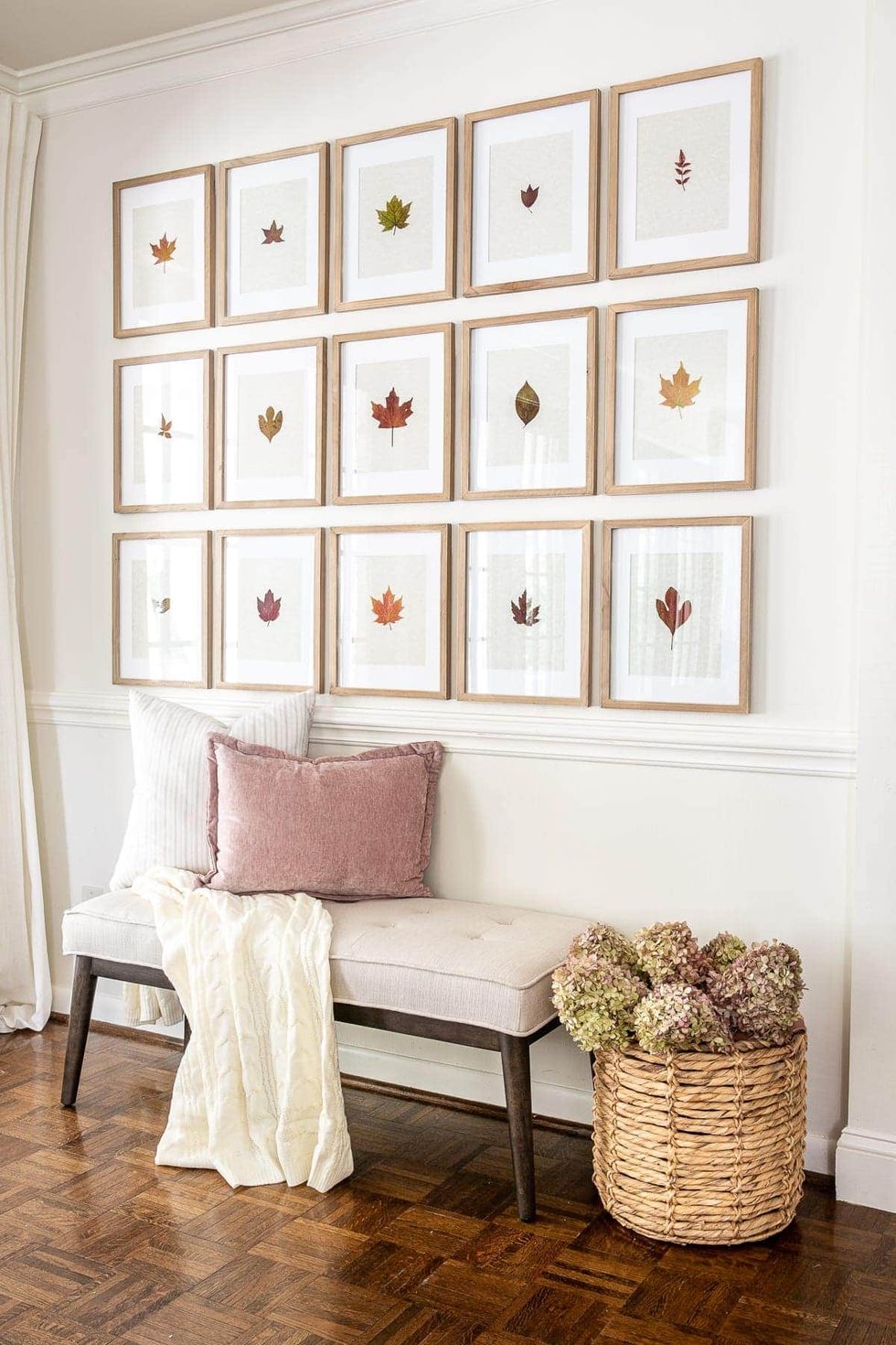 fall decor ideas pressed leaf art in a gallery wall above a seat