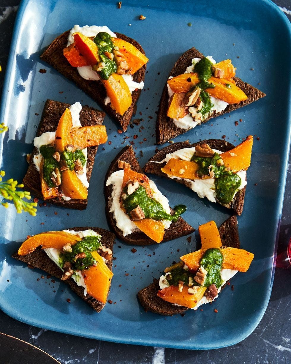 pumpkin and pesto crostini on a cobalt blue serving tray