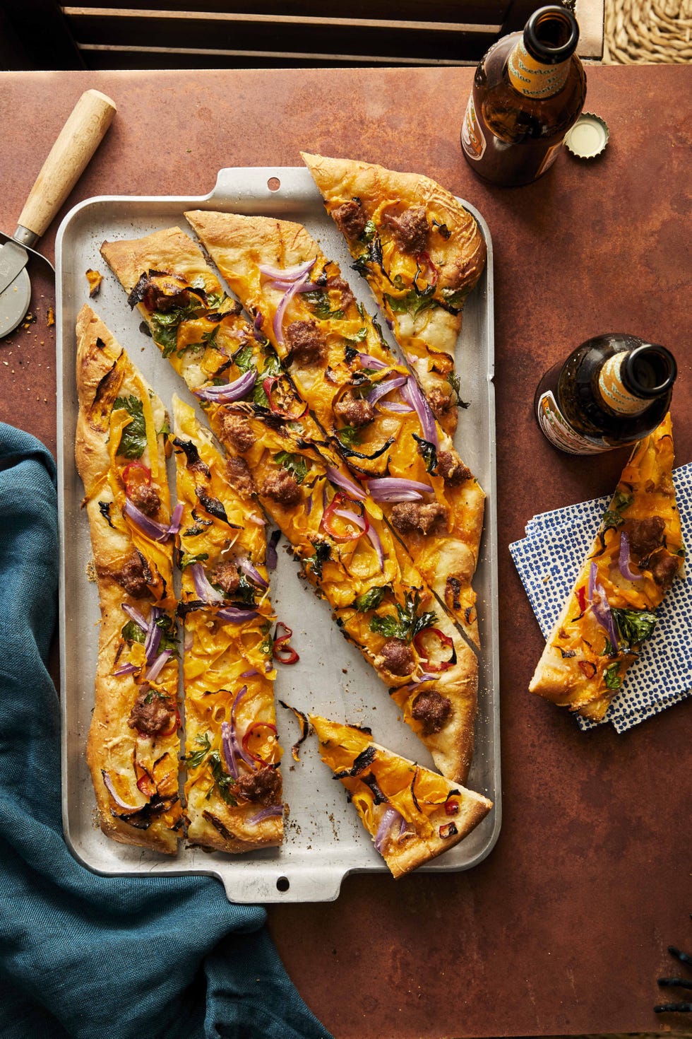 pumpkin chorizo pizza sliced and arranged on a sheet pan