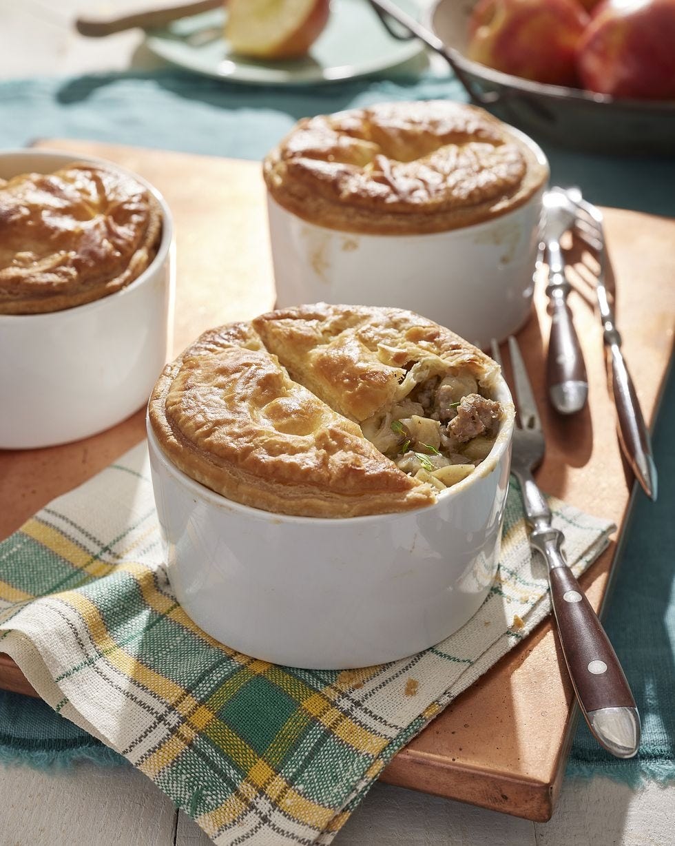 individual sausage and apple pies baked in white ramekins