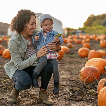 mother and child at a fall festival pumpkin patch