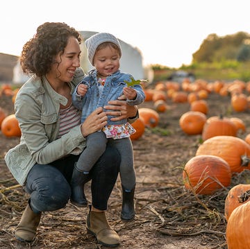 mother and child at a fall festival pumpkin patch