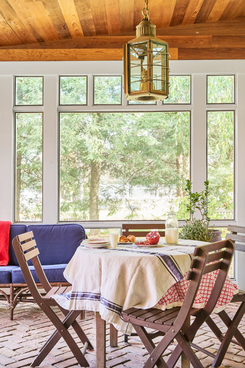 porch with circle table and brown chairs