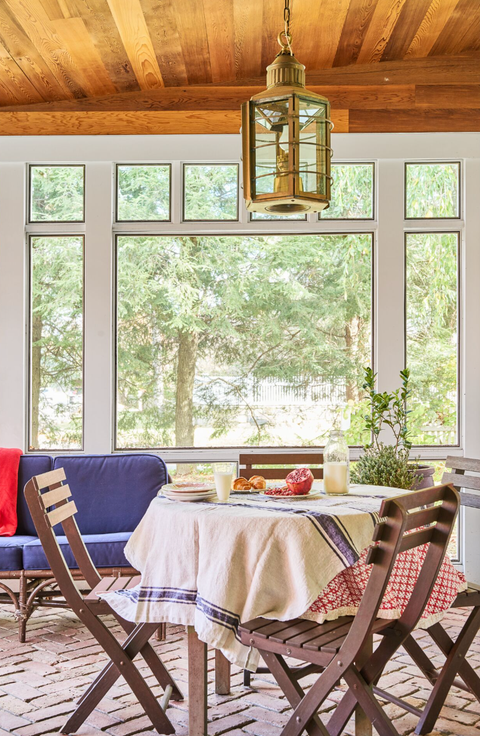 porch with circle table and brown chairs