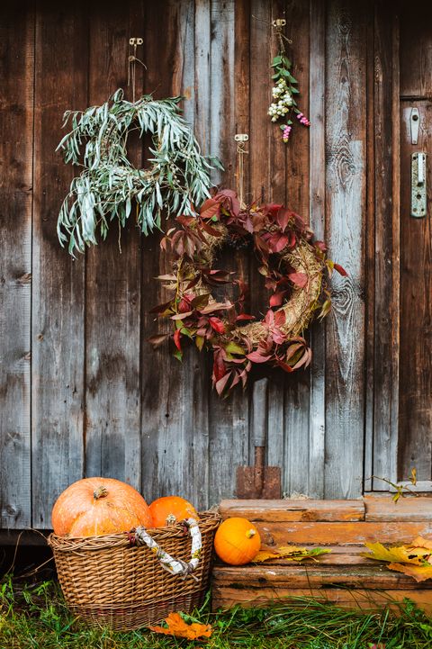 fall front porch autumn wreath and pumpkins on old wooden rustic background at doors autumn composition and copy space for text