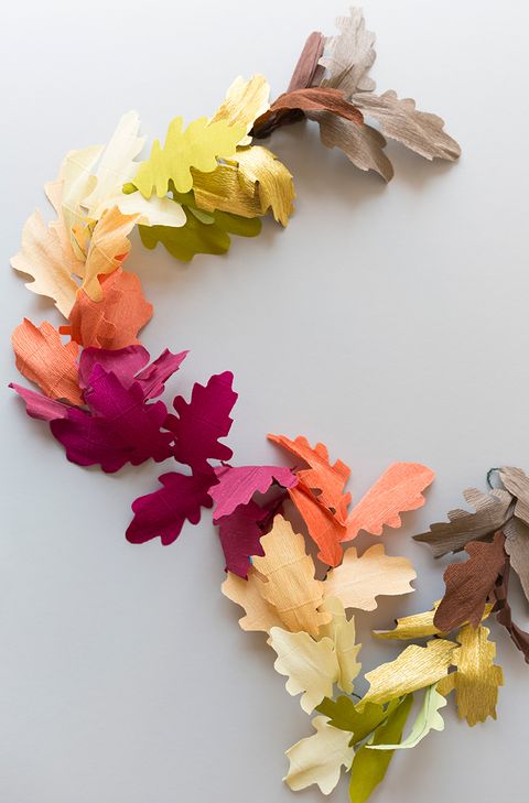 fall leaves crafted from orange, violet, yellow, and brown crepe paper cutouts, strung into a garland
