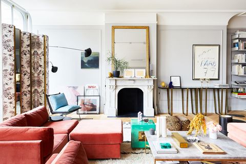 living room with mirror leaning on mantel