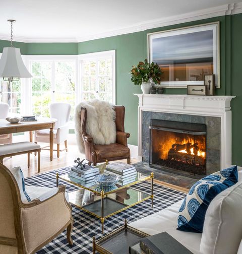 living room with plaid carpet and roaring fireplace