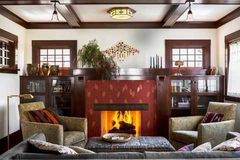 living room with tile fireplace and exposed beams
