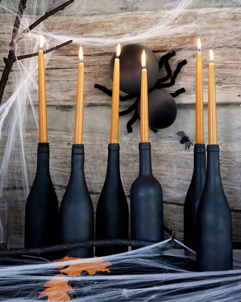 fall mantel with spiders and black wine bottles