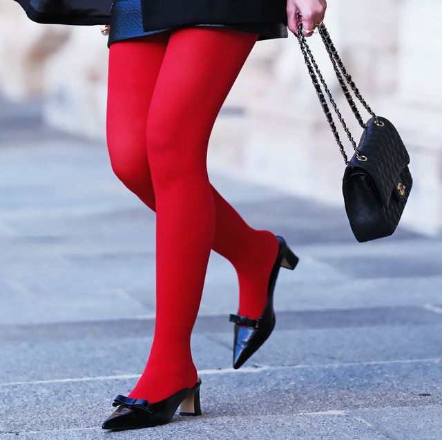 a woman wearing red tights and black high heels