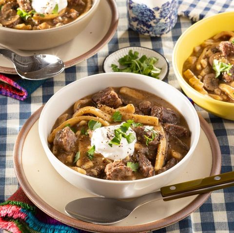 beef and noodles in bowl with sour cream